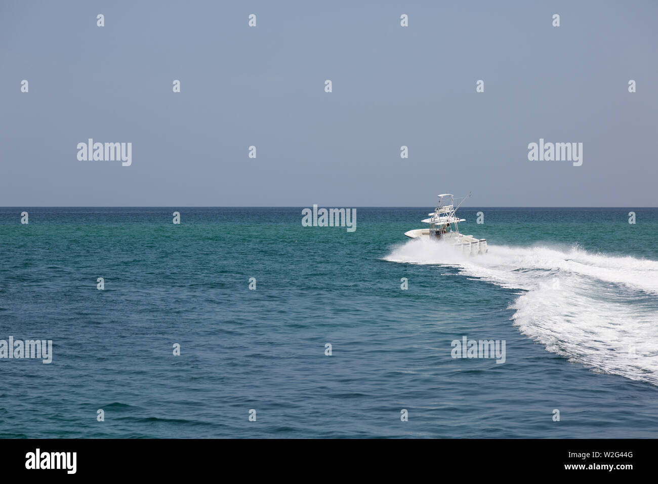 A fishing boat heads toward the open waters of the Atlantic Ocean off South Florida. Stock Photo