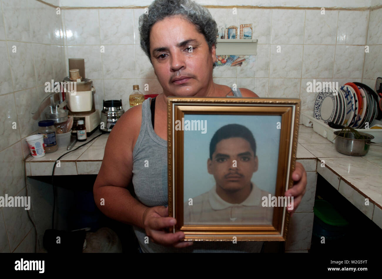 Elena Santiago holds a photograph of her late son Daniel Santiago in her living room in Los Erasos shanty neighborhood in Caracas, July 22, 2008.  Ele Stock Photo