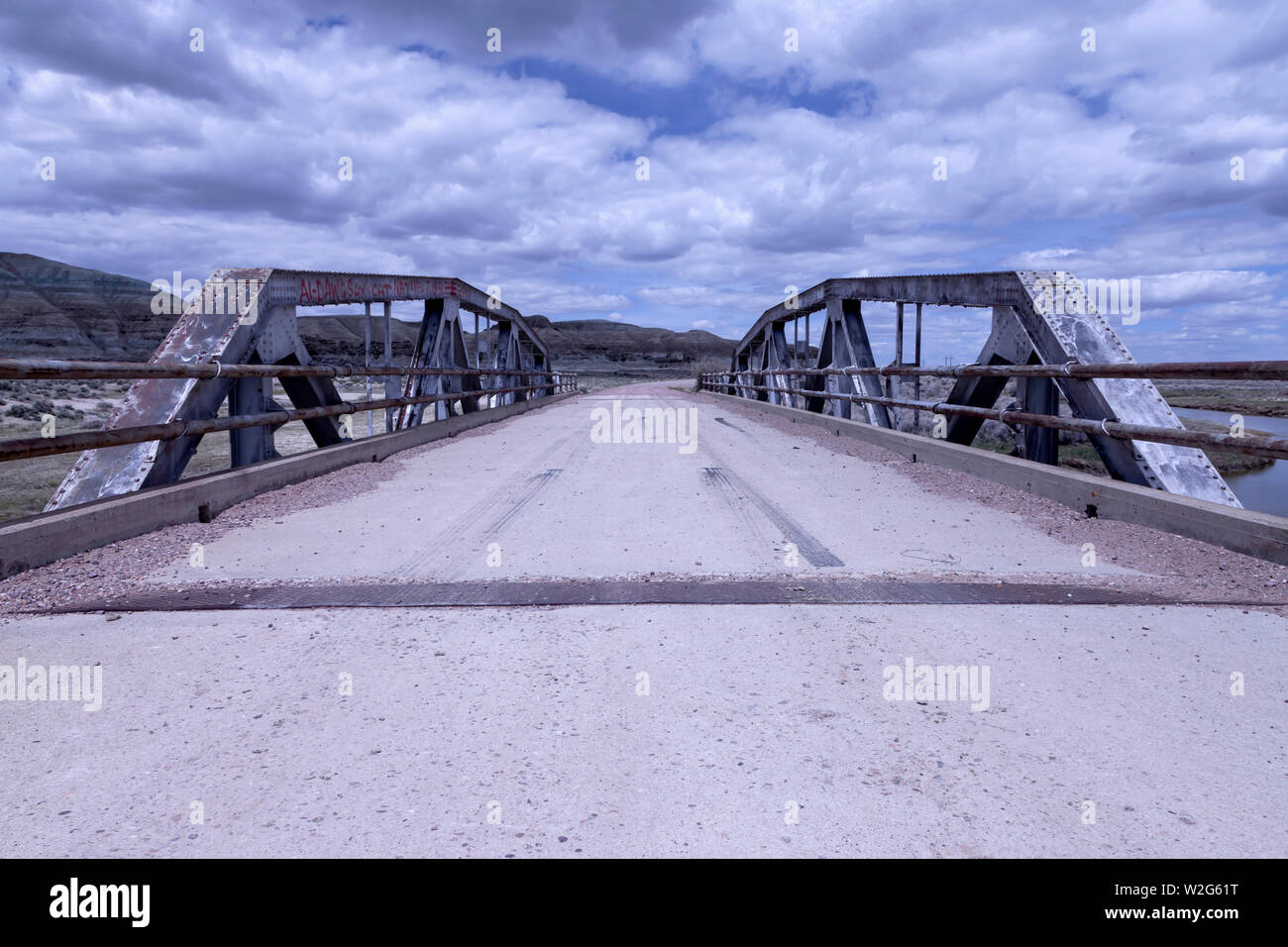 A pony truss bridge carries an alignment of the Lincoln Highway over the Blacks Fork River near Lyman, Wyoming Stock Photo