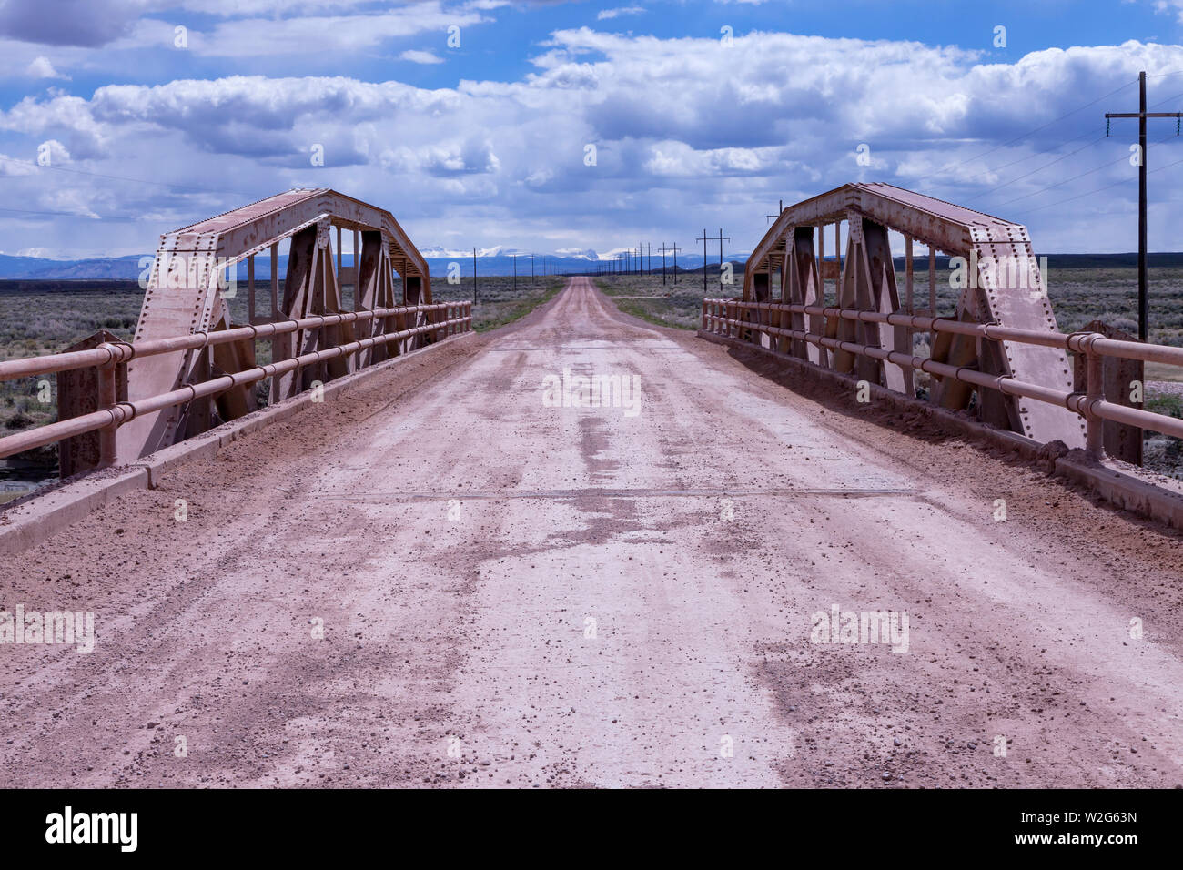 A pony truss bridge carries an alignment of the Lincoln Highway over the Blacks Fork River near Granger, Wyoming Stock Photo