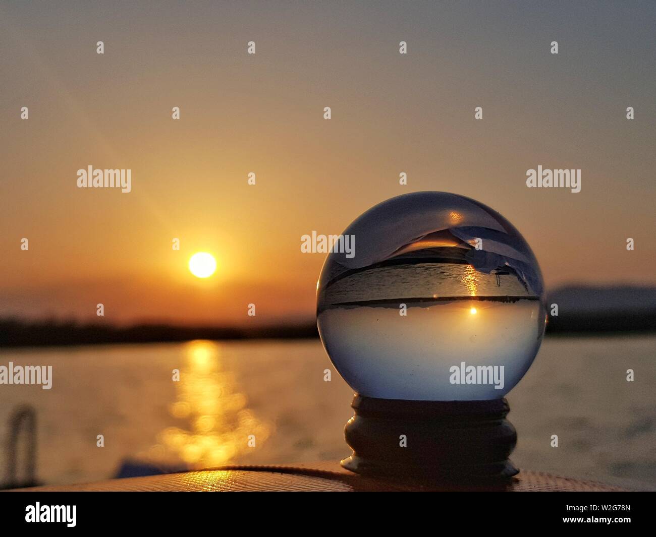 Beautiful shot of the sunset with a reflecting crystal ball up front ...