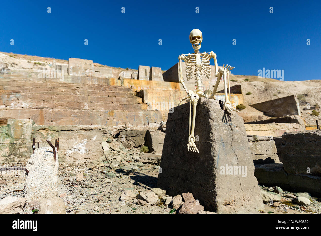 Skeleton posing in mining ruins in the desert on a hot day Stock Photo