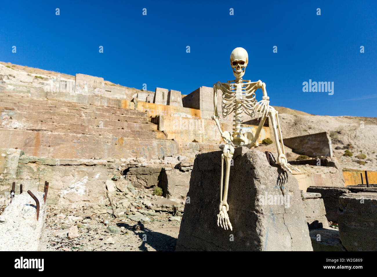 Skeleton posing in mining ruins in the desert on a hot day Stock Photo