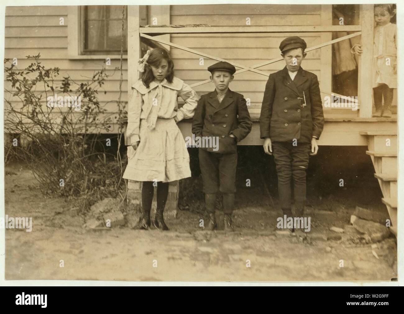 Children of night superintendent, in Dickson Mill, Laurinburg, N.C. (1) Bessie Moore - runs 4 sides. Has worked two years nights. (2) Frank (smallest). Doffs. Has worked 2 yrs. nights. (3) Stock Photo