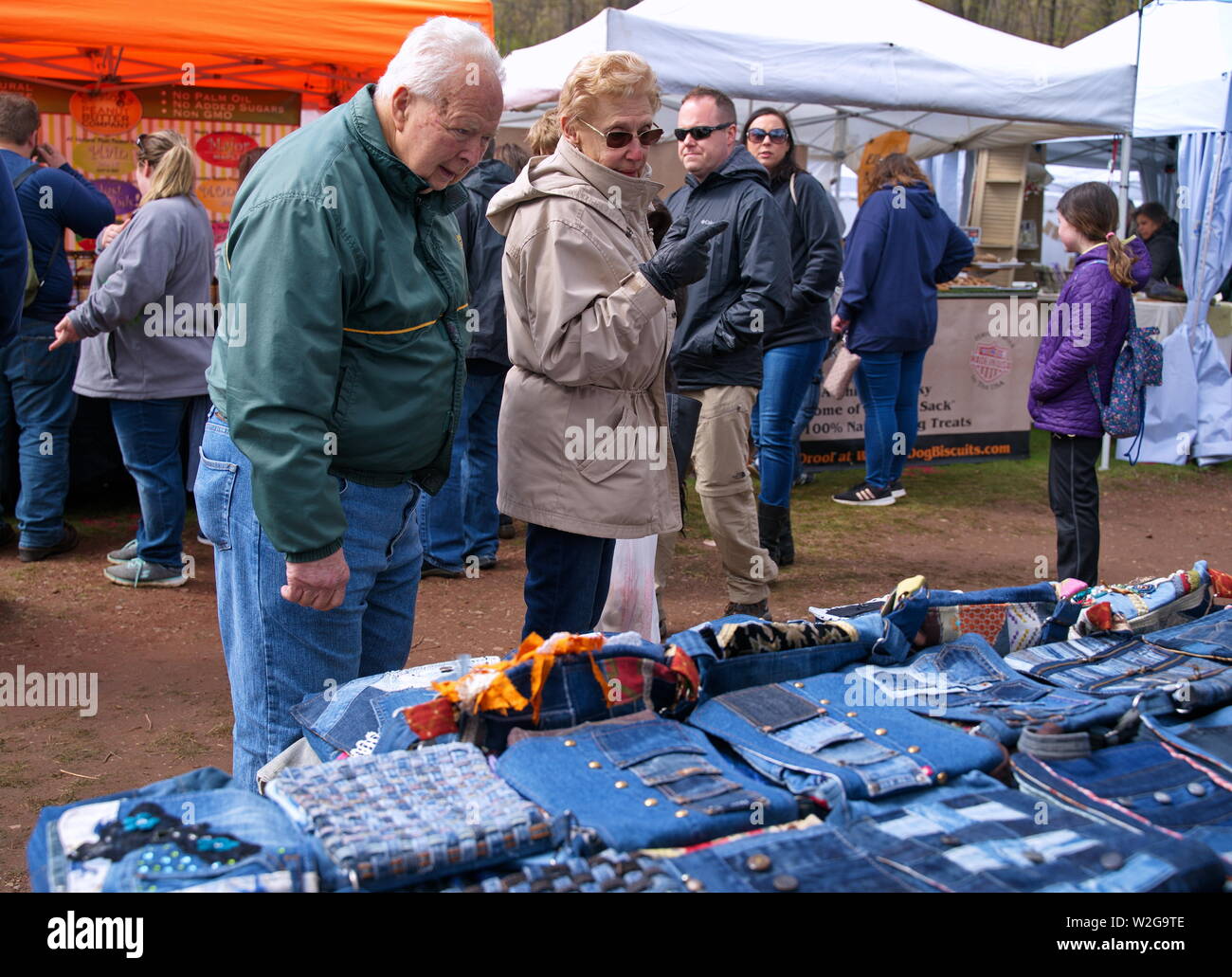 Meriden, CT USA. Apr 2019. Daffodil Festival. Elderly couple looking at clothing and good sales. Stock Photo