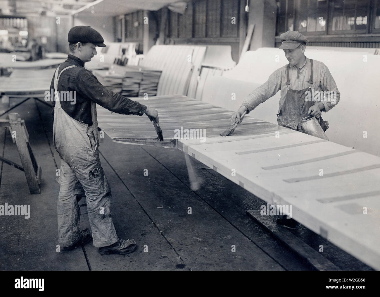 Airplane production - Applying 'dope' to a finished airplane wing ca. 1917 Stock Photo