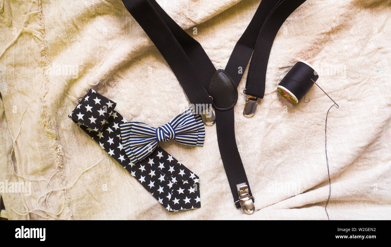 bow tie neck tie and braces for baby boy background Stock Photo Alamy