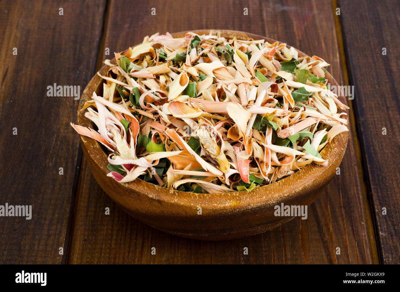 Dried lemongrass leaves in wooden bowl.  Stock Photo
