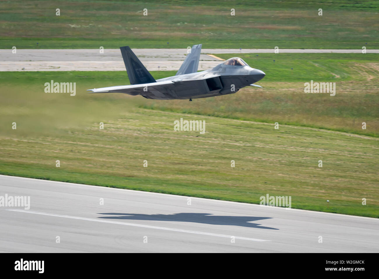 U.S. Air Force Maj. Paul Lopez, F-22 Demo Team commander, takes off in Battle Creek, Mich. for the Field of Flight air show July 7, 2019. Representing the U.S. Air Force and Air Combat Command, the F-22 Demo Team travels to 25 air shows a season to showcase the performance and capabilities of the world's premier 5th-generation fighter. (U.S. Air Force photo by 2nd Lt. Samuel Eckholm) Stock Photo