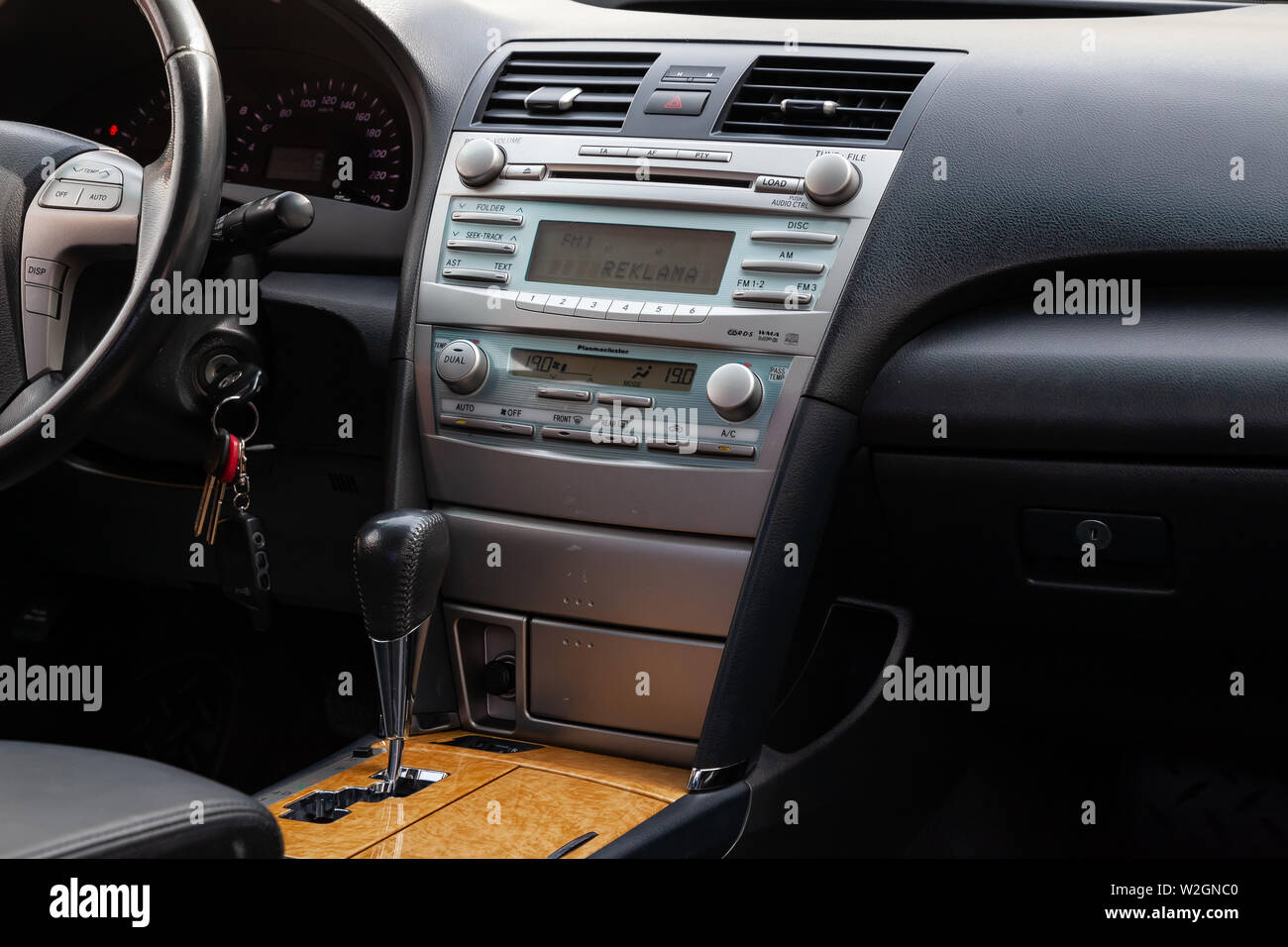 Novosibirsk, Russia - 07.09.2019: View to the interior of Toyota Camry 2006 with dashboard, clock, media system, front seats, gray leather and shiftge Stock Photo