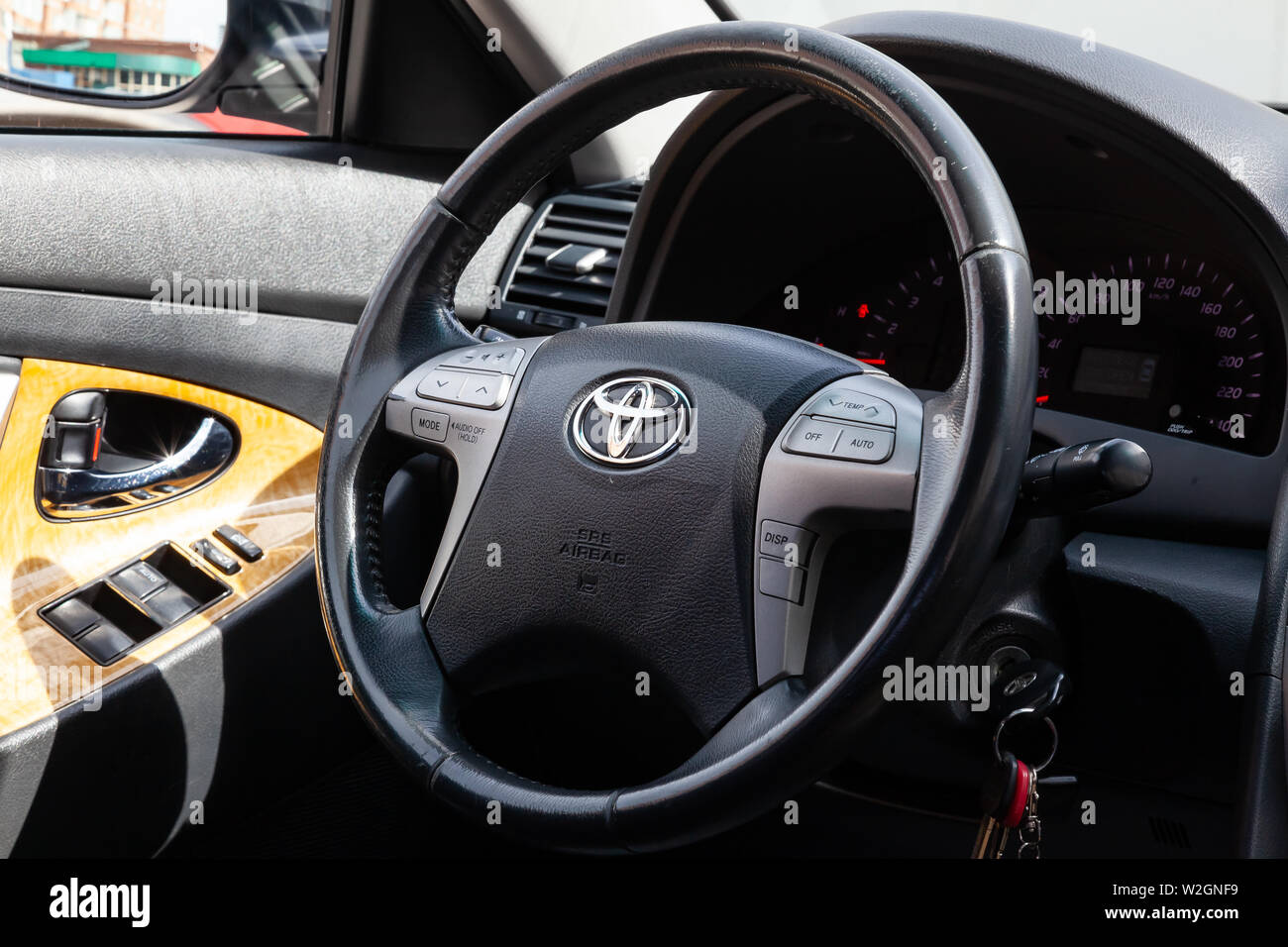 Novosibirsk, Russia - 07.09.2019: View to the interior of Toyota Camry 2006 with dashboard, clock, media system, front seats, gray leather and shiftge Stock Photo