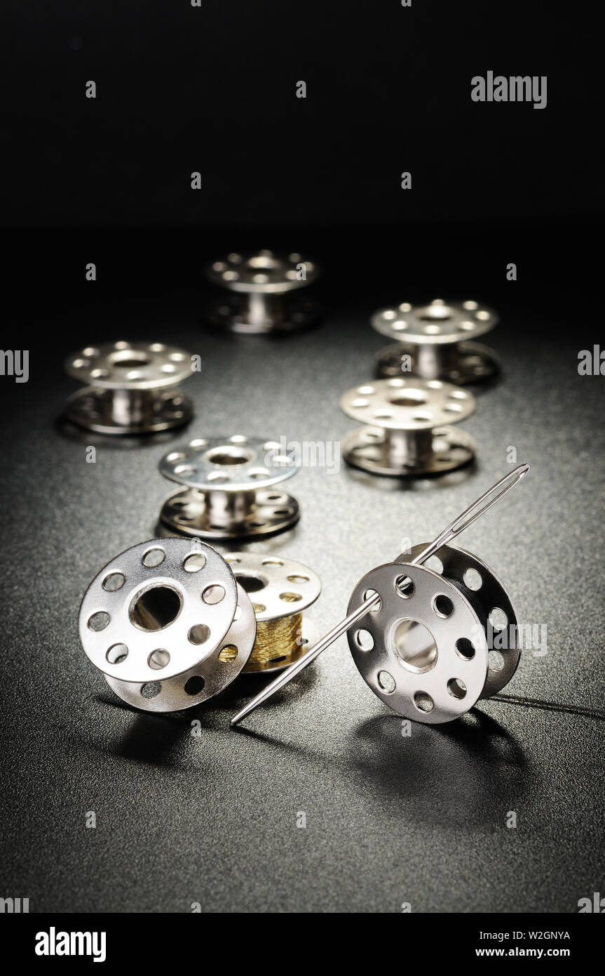 Metal spools of sewing machine on a black background Stock Photo Alamy