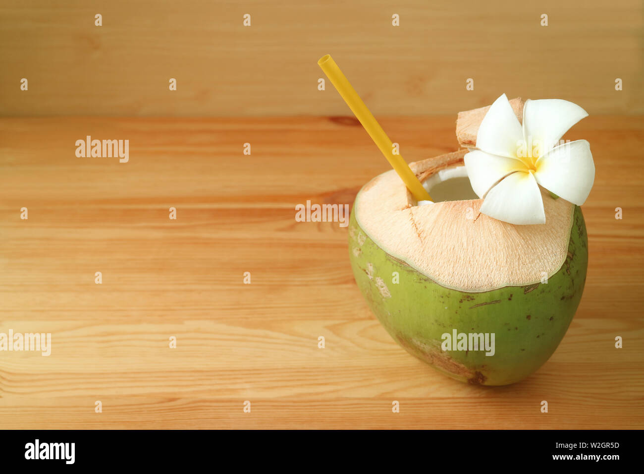 Fresh Young Coconut Water In Coconut Shell With Plumeria Flower On Wooden Table Stock Photo Alamy