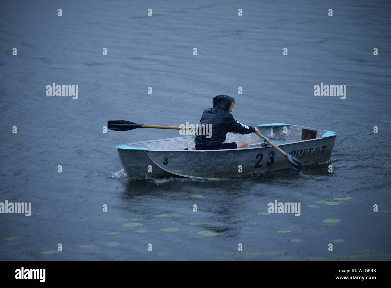 Man rowing boat rain hires stock photography and images Alamy