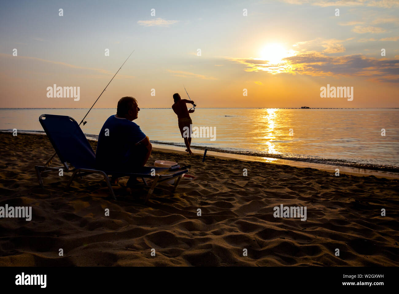 Silhouette two men sea fishing hi-res stock photography and images - Alamy