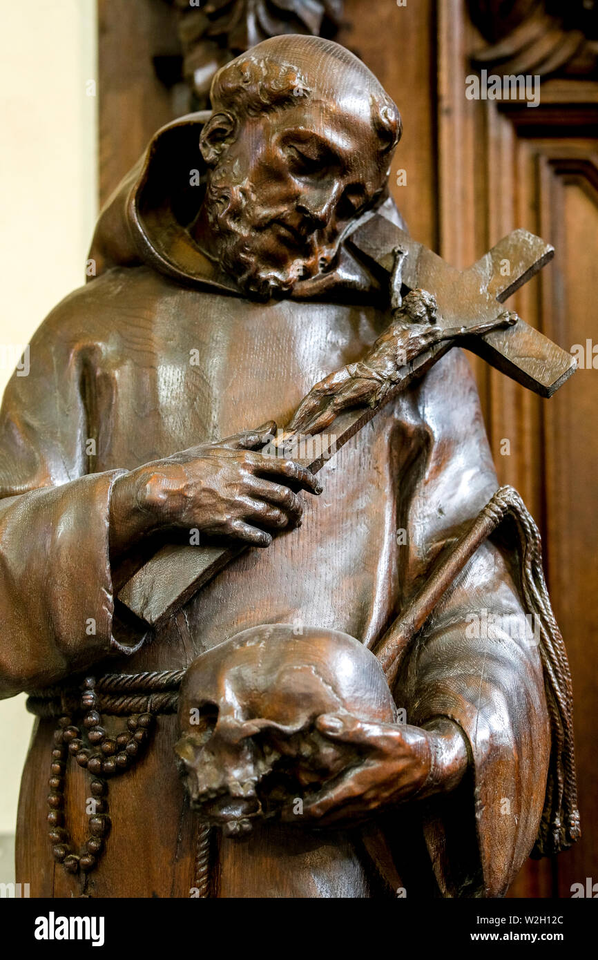 St James's catholic church, Antwerp, Belgium. Statue of a saint holding a cross and a skull. Stock Photo