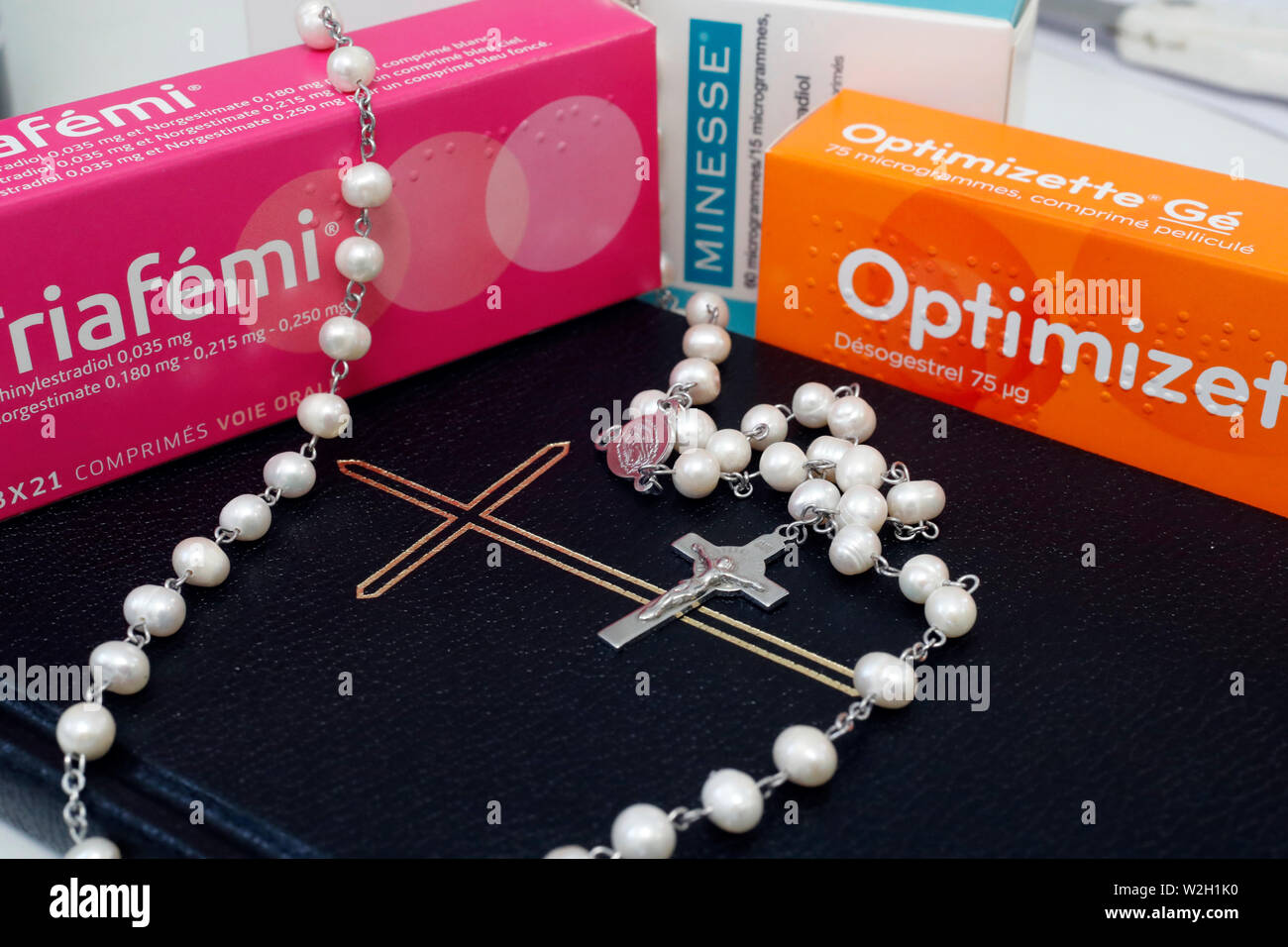 Combined oral contraceptive pill (COCP)  catholic rosary and bible.  France. Stock Photo