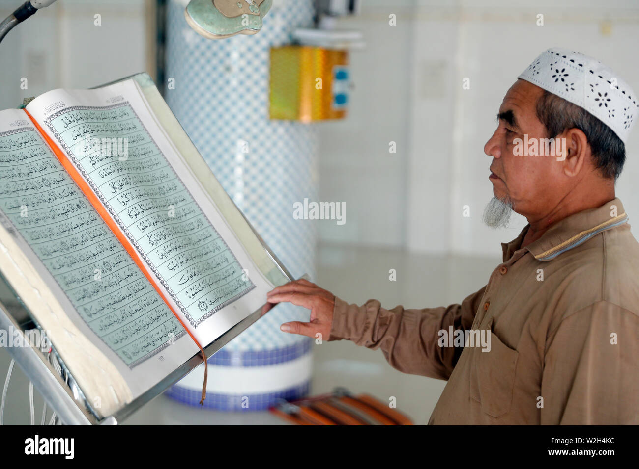 Masjid Nurul Naim mosque. Imam reading the Quran. Phnom Penh. Cambodia
