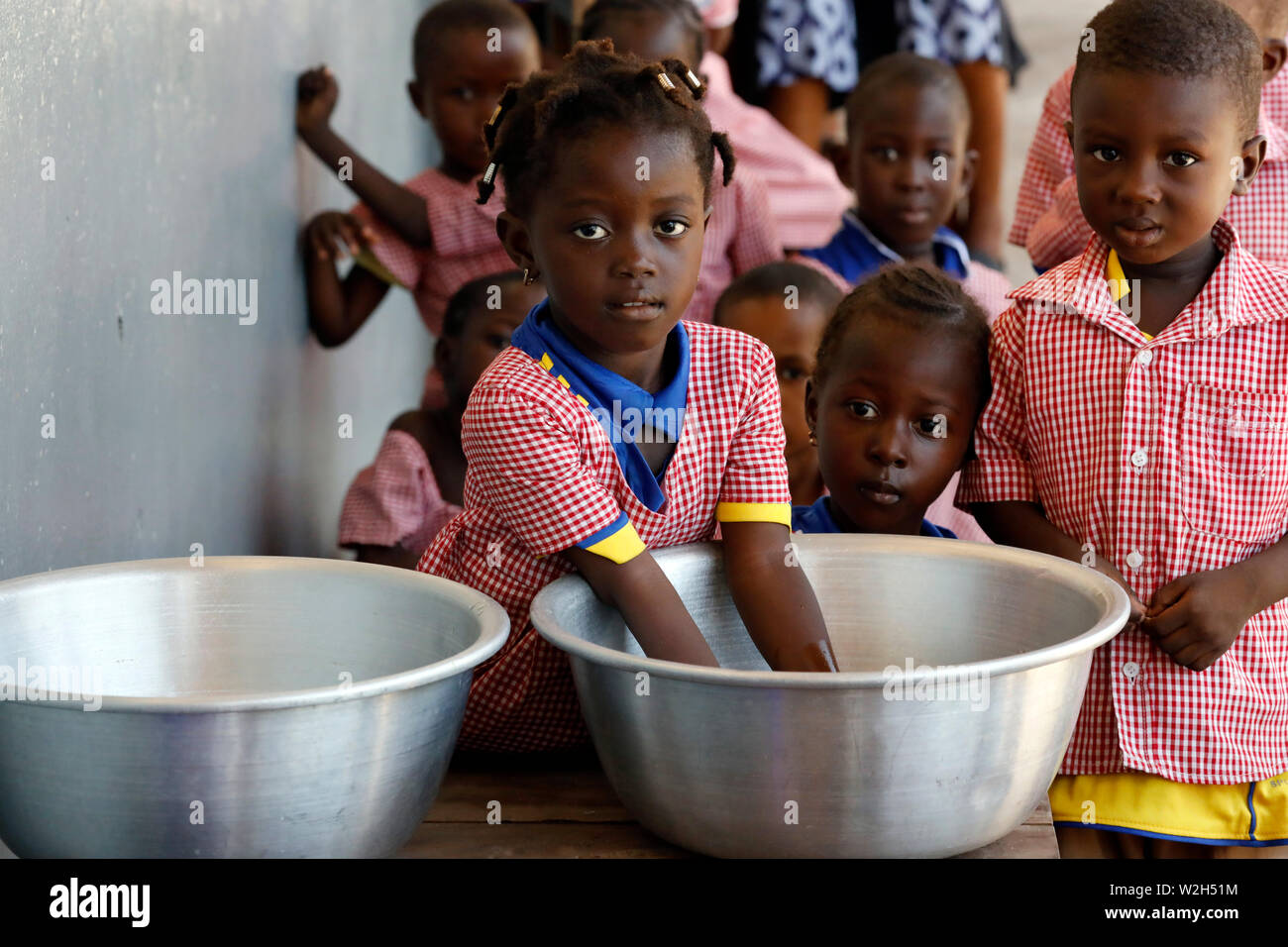 African primary school. A school girl washing his hands. Lome. Togo. Stock Photo
