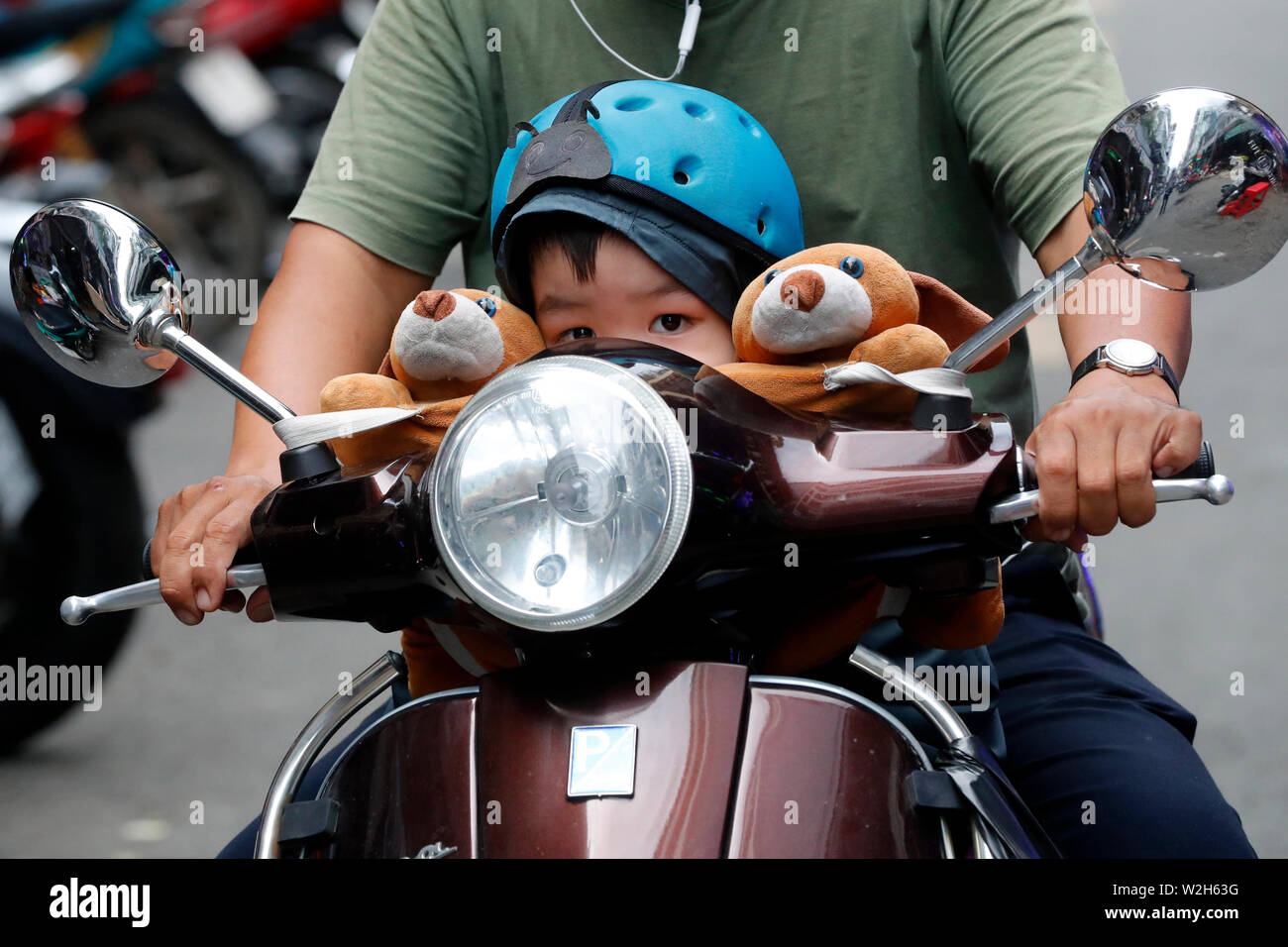 Vietnamese family on a scooter. Road traffic. Ho Chi Minh city. Vietnam. Stock Photo