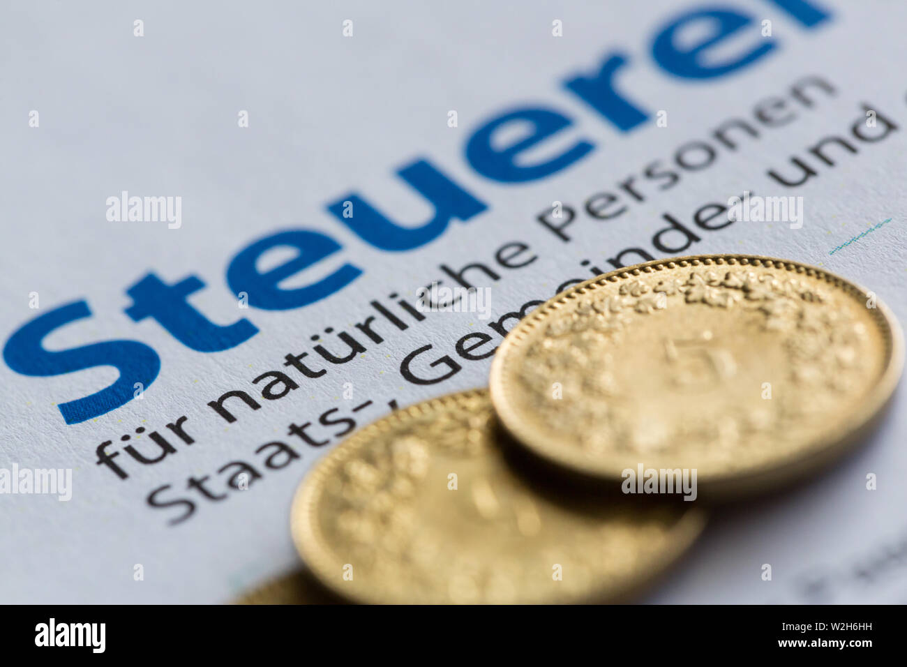 Swiss golden coins and Zurich tax filing form Stock Photo
