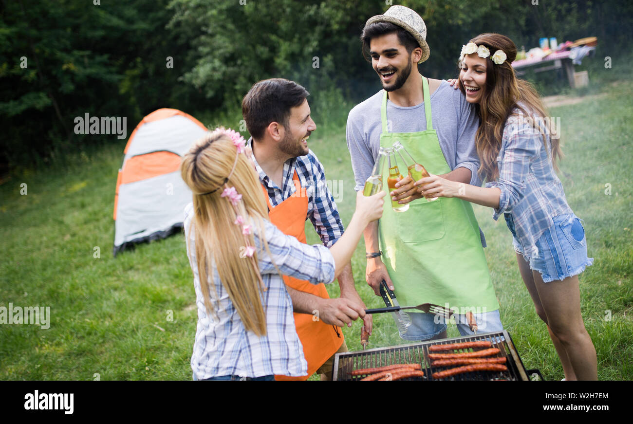 Group of happy friends having barbecue party in forest Stock Photo - Alamy