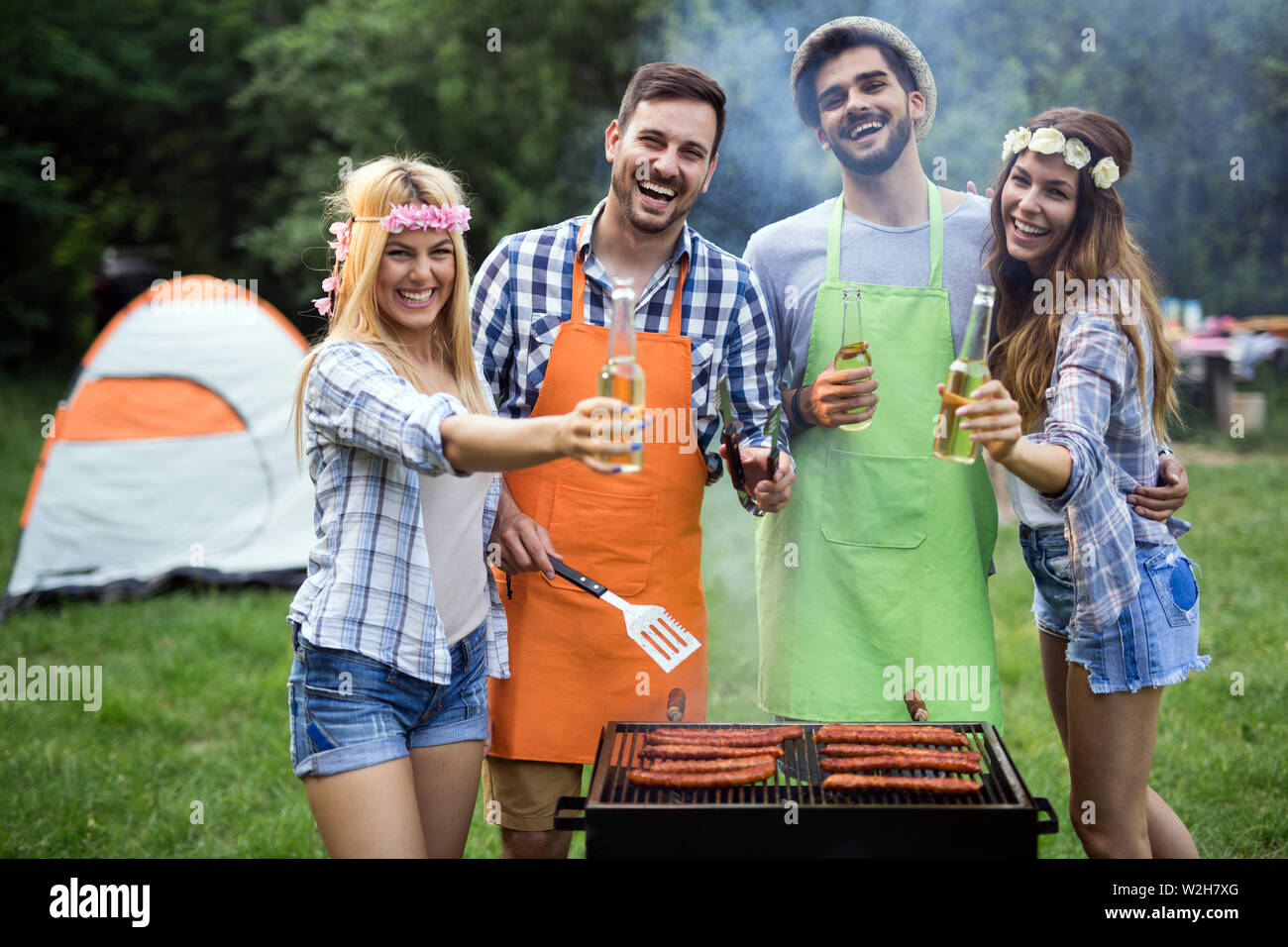 Group of happy friends having barbecue party in forest Stock Photo - Alamy