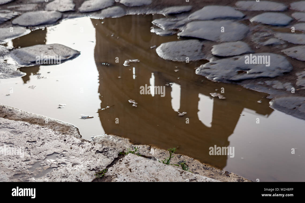 Coliseum reflection in a puddle - Rome, Italy Stock Photo
