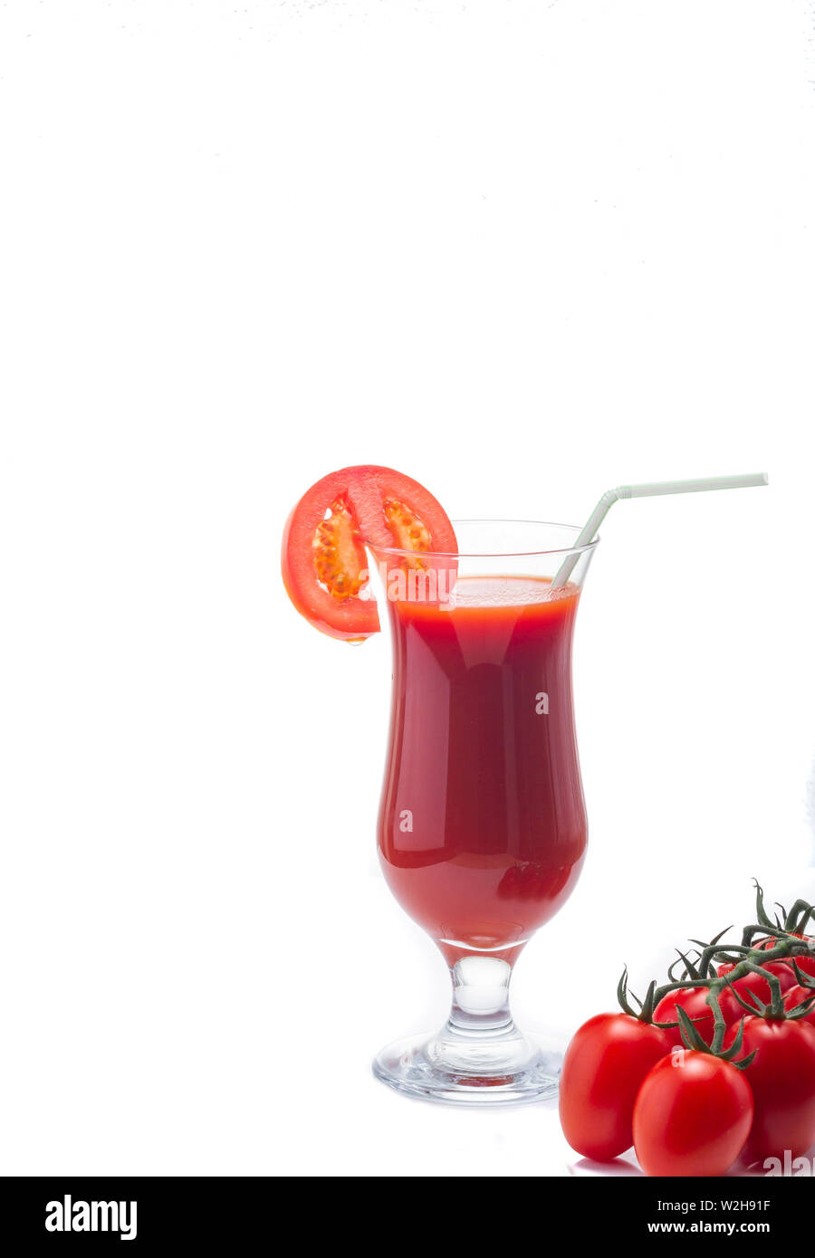 Fresh tomato juice. Juice in a glass. Red juice. Healthy drink. Tomatoes in the diet. Stock Photo