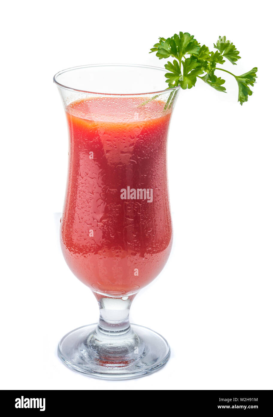 Fresh tomato juice. Juice in a glass. Red juice. Healthy drink. Tomatoes in the diet. Stock Photo