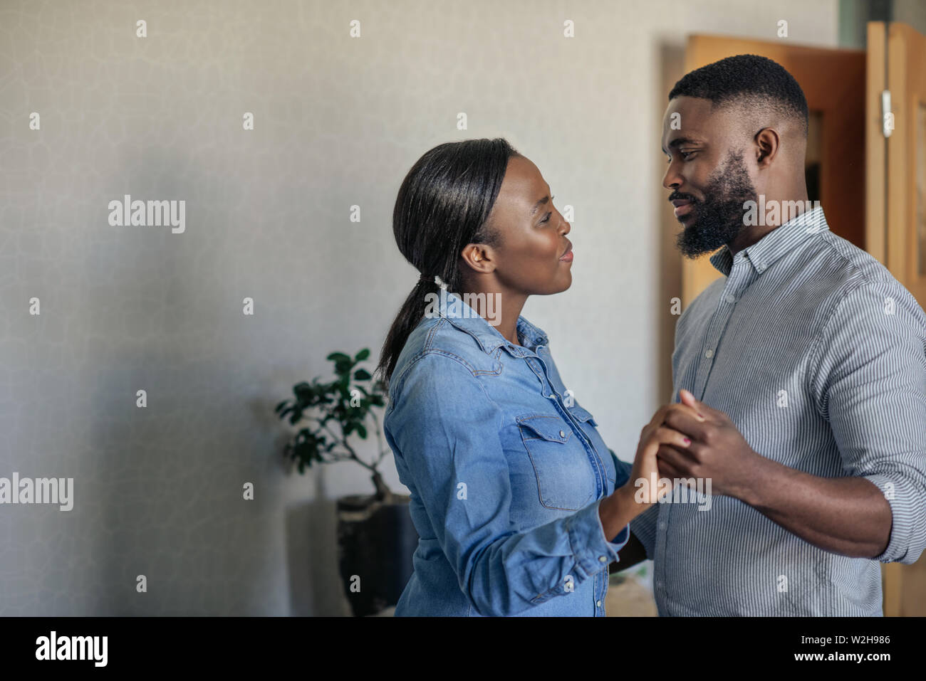 Affectionate young African American couple dancing together at home Stock Photo