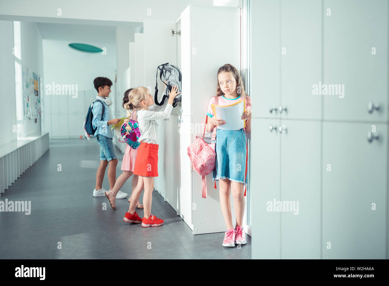 Children using their school lockers while having break from lesson Stock Photo