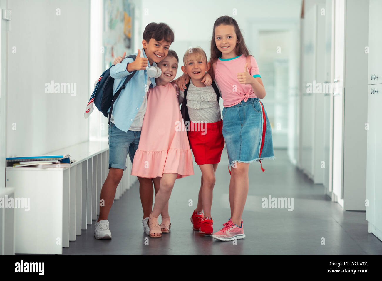 Cheerful pupils feeling happy after finishing school year Stock Photo