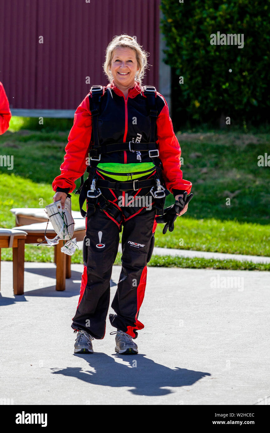 A Middle Aged Female Prepares To Go Skydiving, Queenstown, South Island, New Zealand Stock Photo