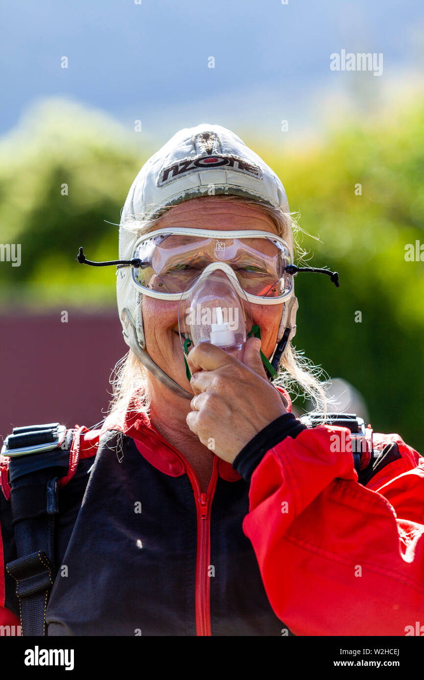 A Middle Aged Female Prepares To Go Skydiving, Queenstown, South Island, New Zealand Stock Photo
