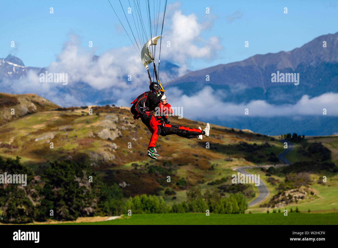 Tandem Skydivers Preparing To Land, Queenstown, South Island, New Zealand Stock Photo