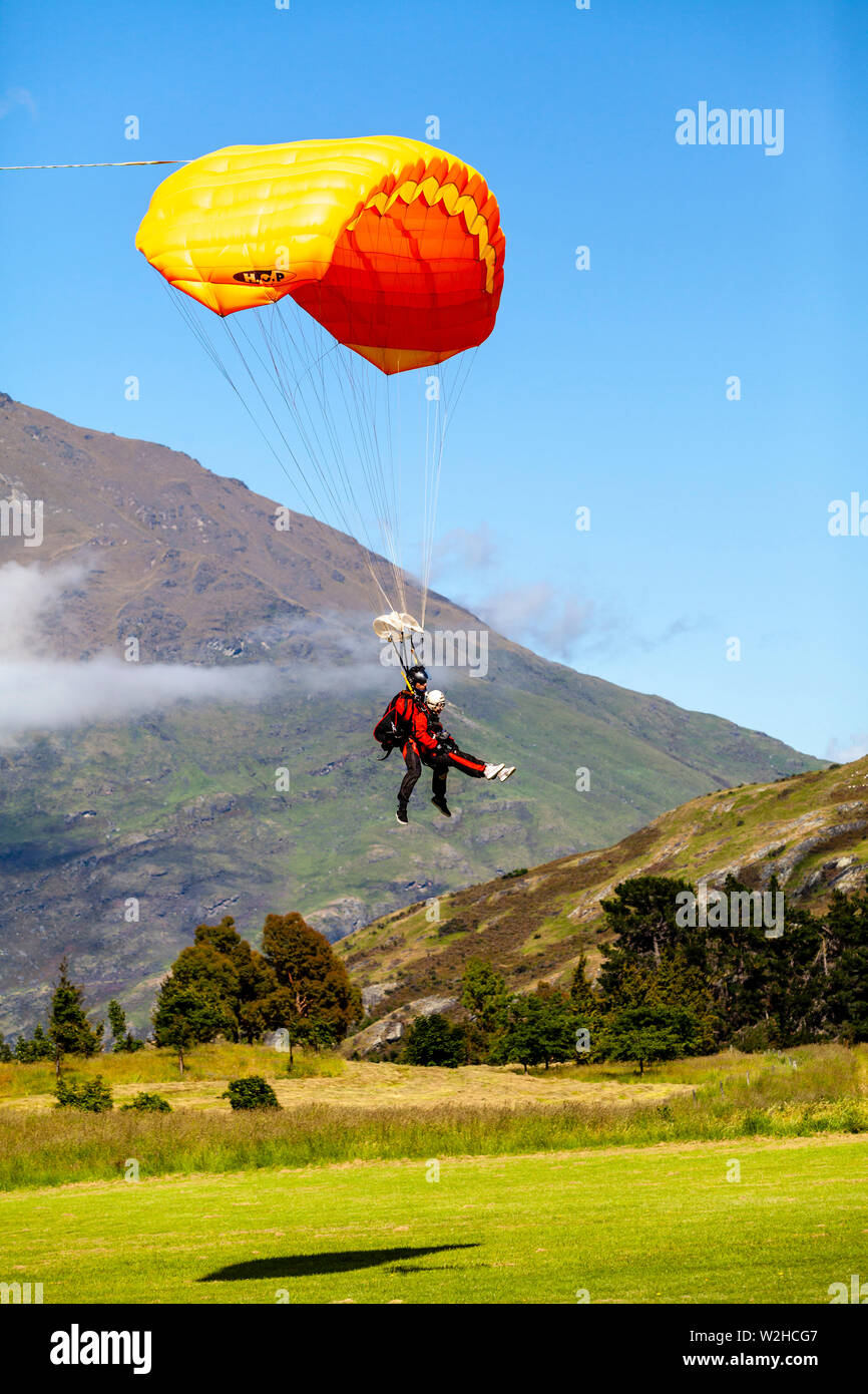 Tandem Skydivers Preparing To Land, Queenstown, South Island, New Zealand Stock Photo