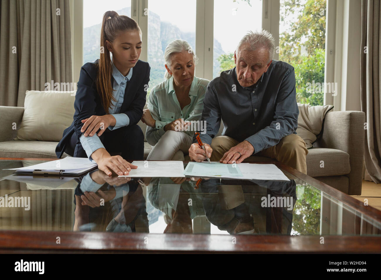 Senior couple signing documents hi-res stock photography and images - Alamy