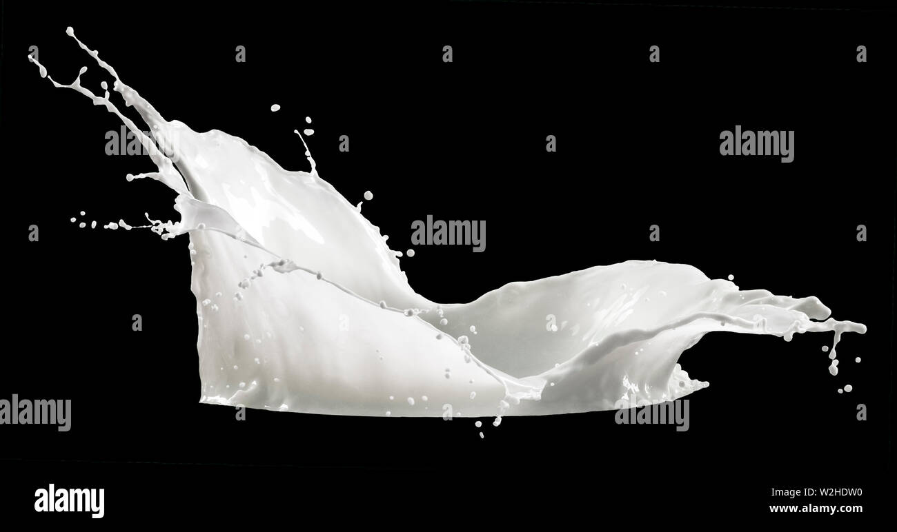 milk splash isolated on black background Stock Photo - Alamy