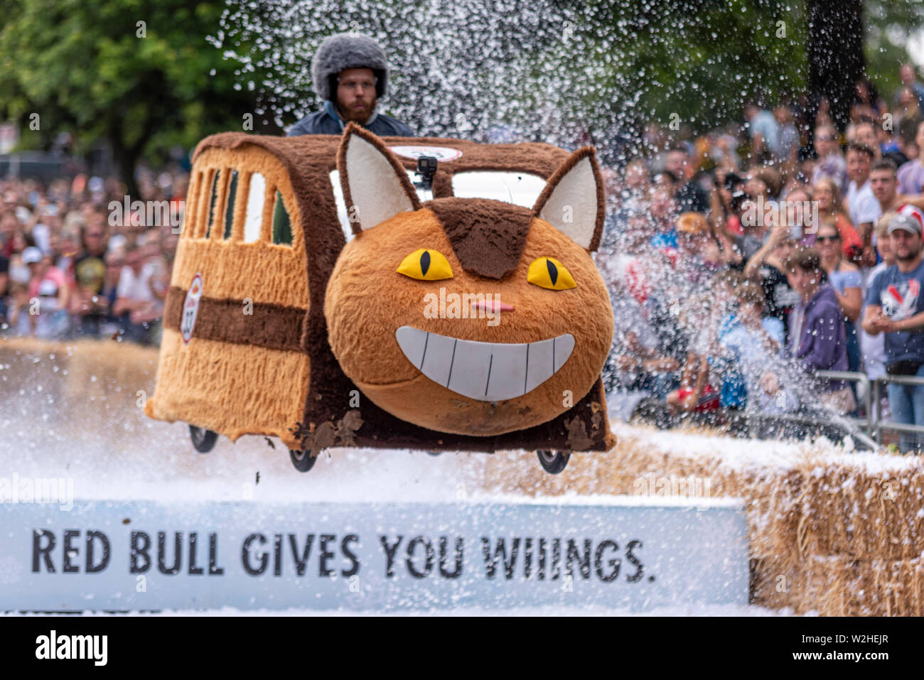 Team Totoro Catbus competing in the Red Bull Soapbox Race 2019 at Alexandra Park, London, UK. Jumping over ramp with people Stock Photo