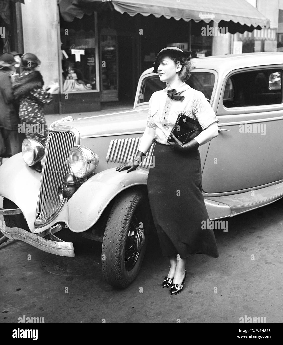 Woman standing outside of an automobile (car) ca. 1935 Stock Photo - Alamy