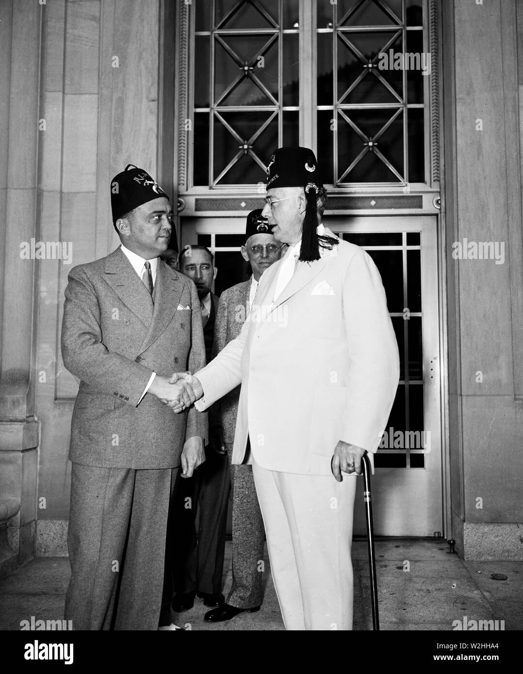 Shrine greeted by head 'G' man. J. Edgar Hoover, head of the Department of Justice's Bureau of Investigation ('G' Men to you) left, greets Imperial Potentate Dana S. Williams of Maine as the Shriners begin their national convention. 6/10/35 Stock Photo