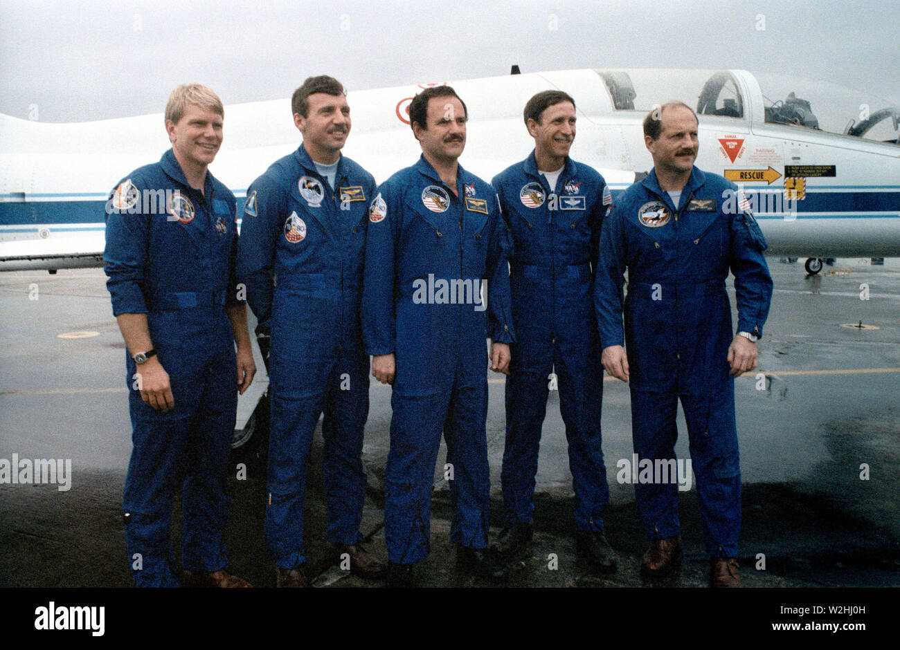 (26 Feb 1987)  --- The five veteran astronauts recently assigned to the STS 26 space mission pose for photographers prior to departure from Ellington Field in T-38 jets (parked in background).  Astronaut Frederick H. (Rick) Hauck (right) is mission commander.  Astronaut Richard O. Covey, second right, is pilot; and (l.-r.)  Astronauts George D. Nelson, David C. Hilmers and John M. (Mike) Lounge are mission specialists. Stock Photo