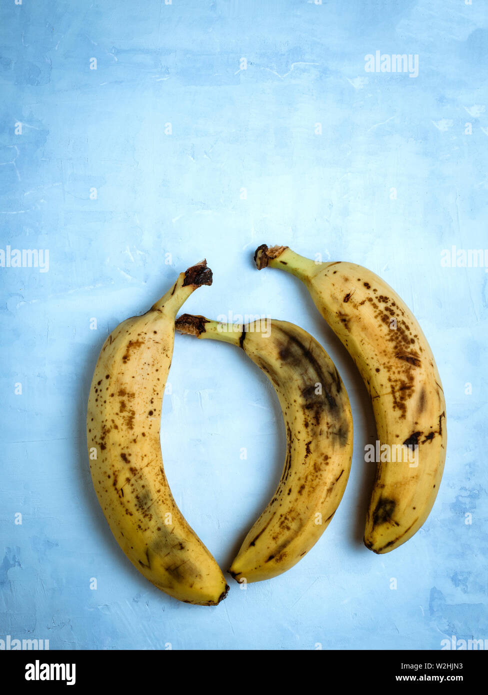 Old banana on light blue background. Zero waste concept. Save the lone banana. Stock Photo
