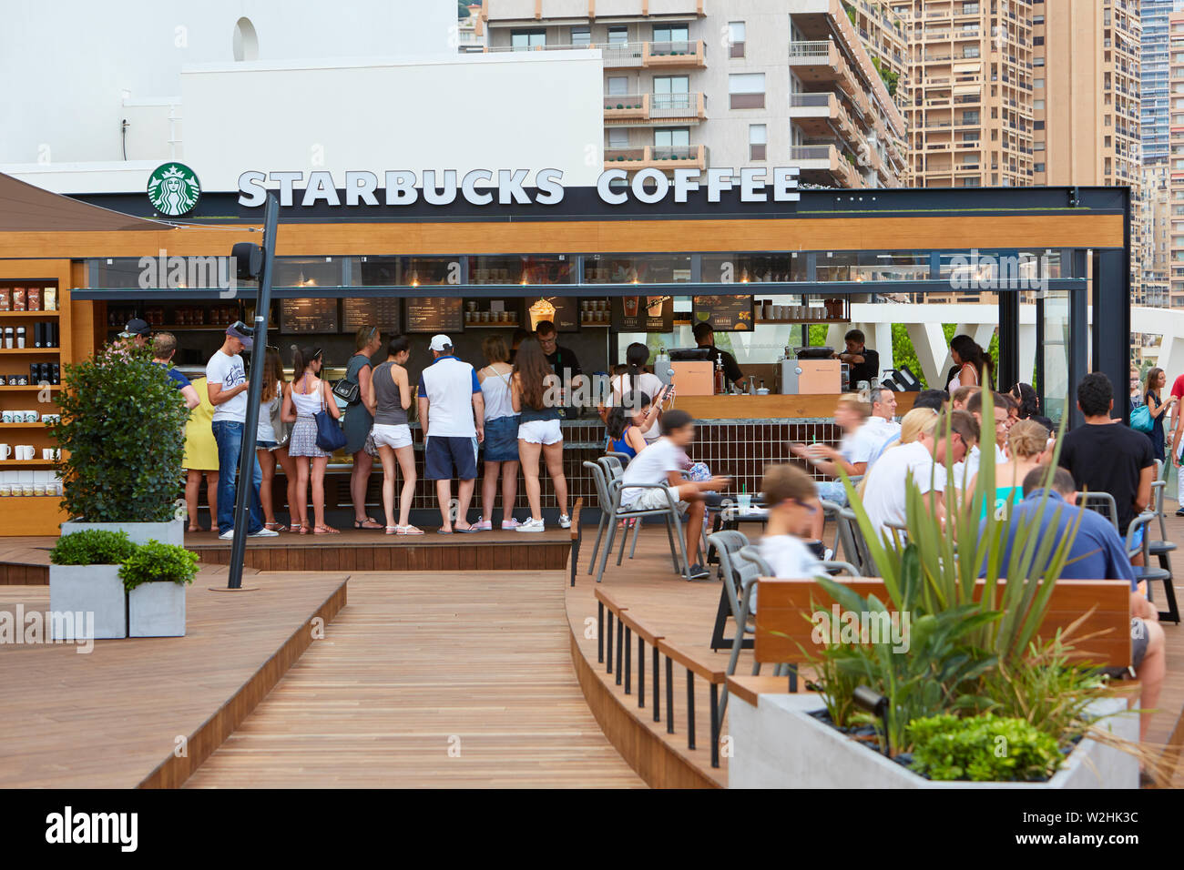 MONTE CARLO, MONACO - AUGUST 19, 2016: Starbucks Coffee cafe terrace with people in summer in Monte Carlo, Monaco. Stock Photo