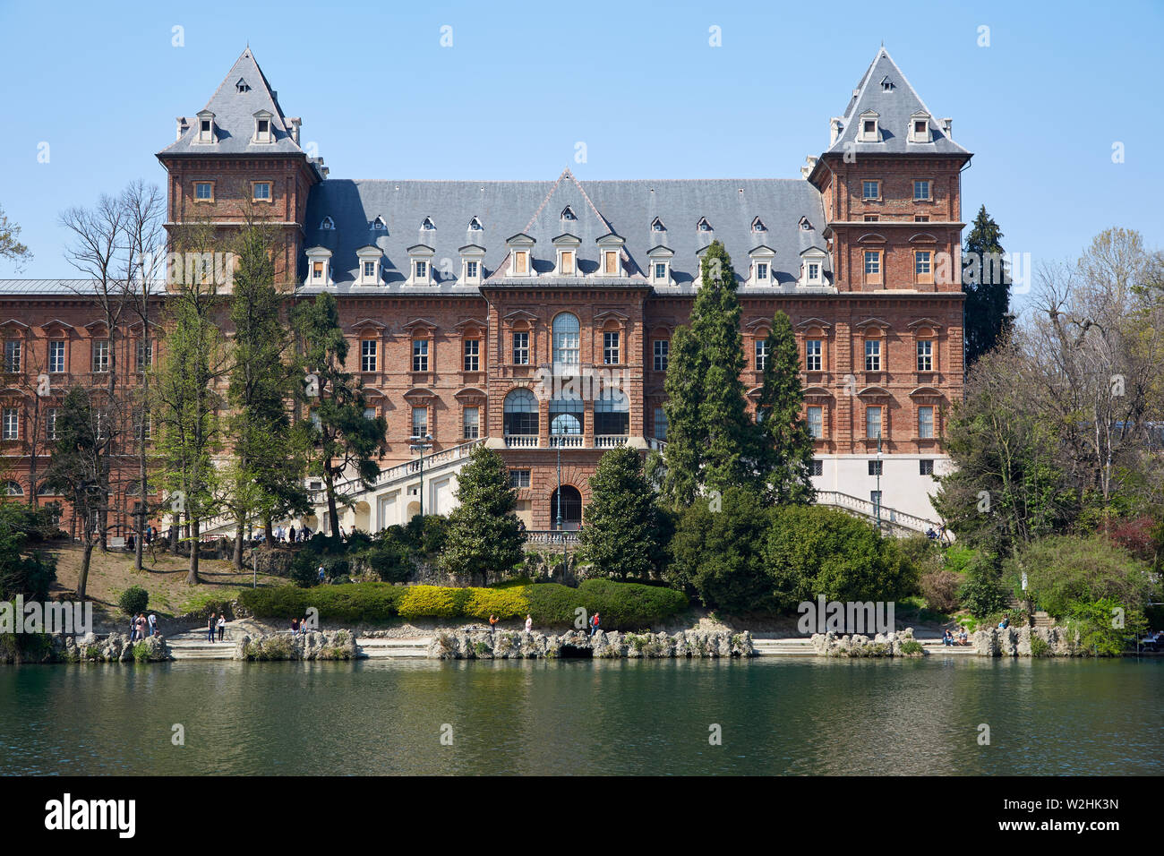 TURIN, ITALY - MARCH 31, 2019: Valentino castle red bricks facade and Po river, clear blue sky in Piedmont, Turin, Italy. Stock Photo