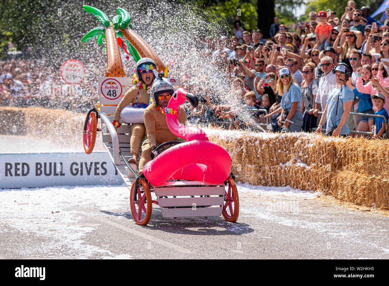 The Honeymooners competing in the Red Bull Soapbox Race 2019 at Alexandra Park, London, UK. Jumping over ramp with people Stock Photo