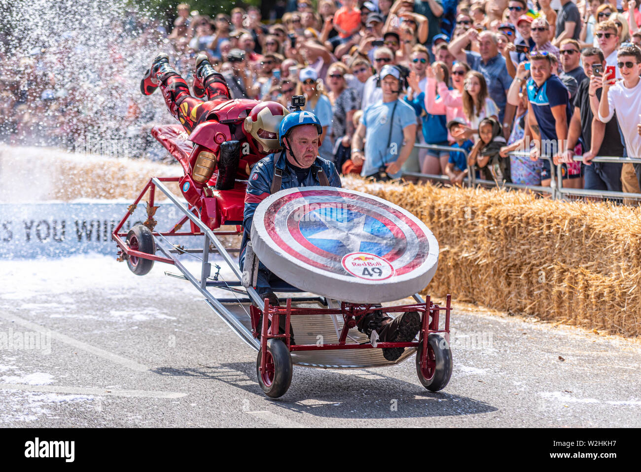 King Kong vs The Avengers competing in the Red Bull Soapbox Race 2019 at Alexandra Park, London, UK. Jumping over ramp with people Stock Photo