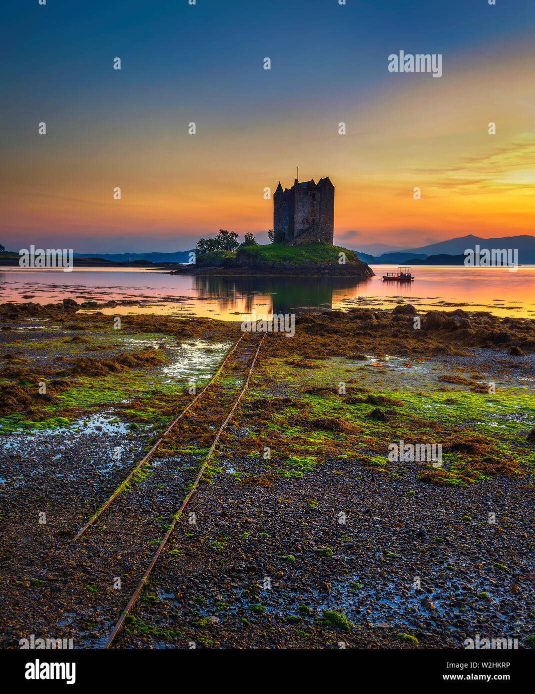 Sunset over Castle Stalker on Loch Appin in Scotland, United Kingdom Stock Photo