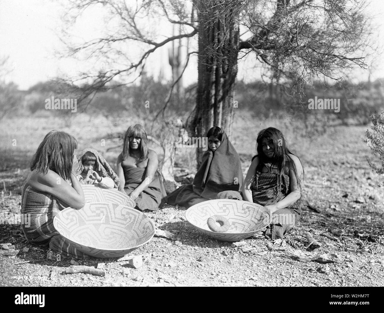 Maricopa group, Arizona. Four women and a child seated on ground with